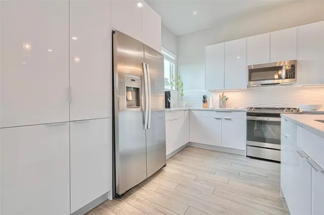 a kitchen with stainless steel appliances a refrigerator sink and stove