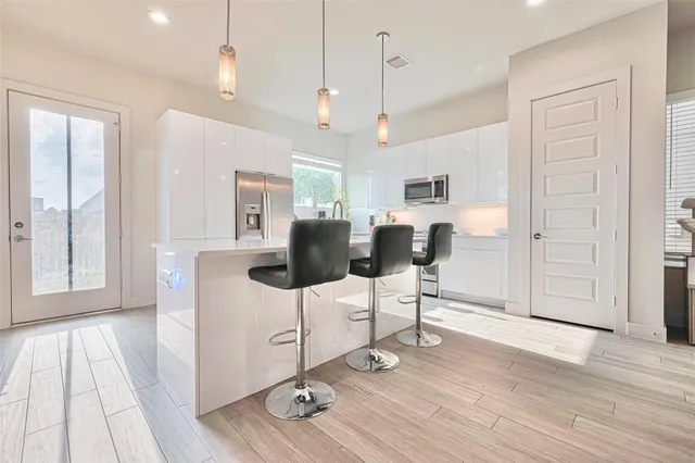 a view of a livingroom with furniture and hardwood floor