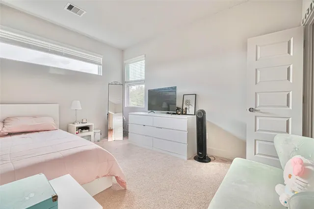 a bedroom with a bed and flat screen tv