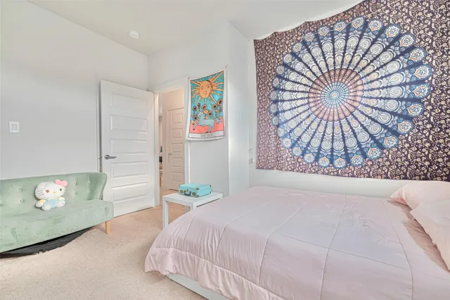 a bedroom with a bed and a painting on the wall