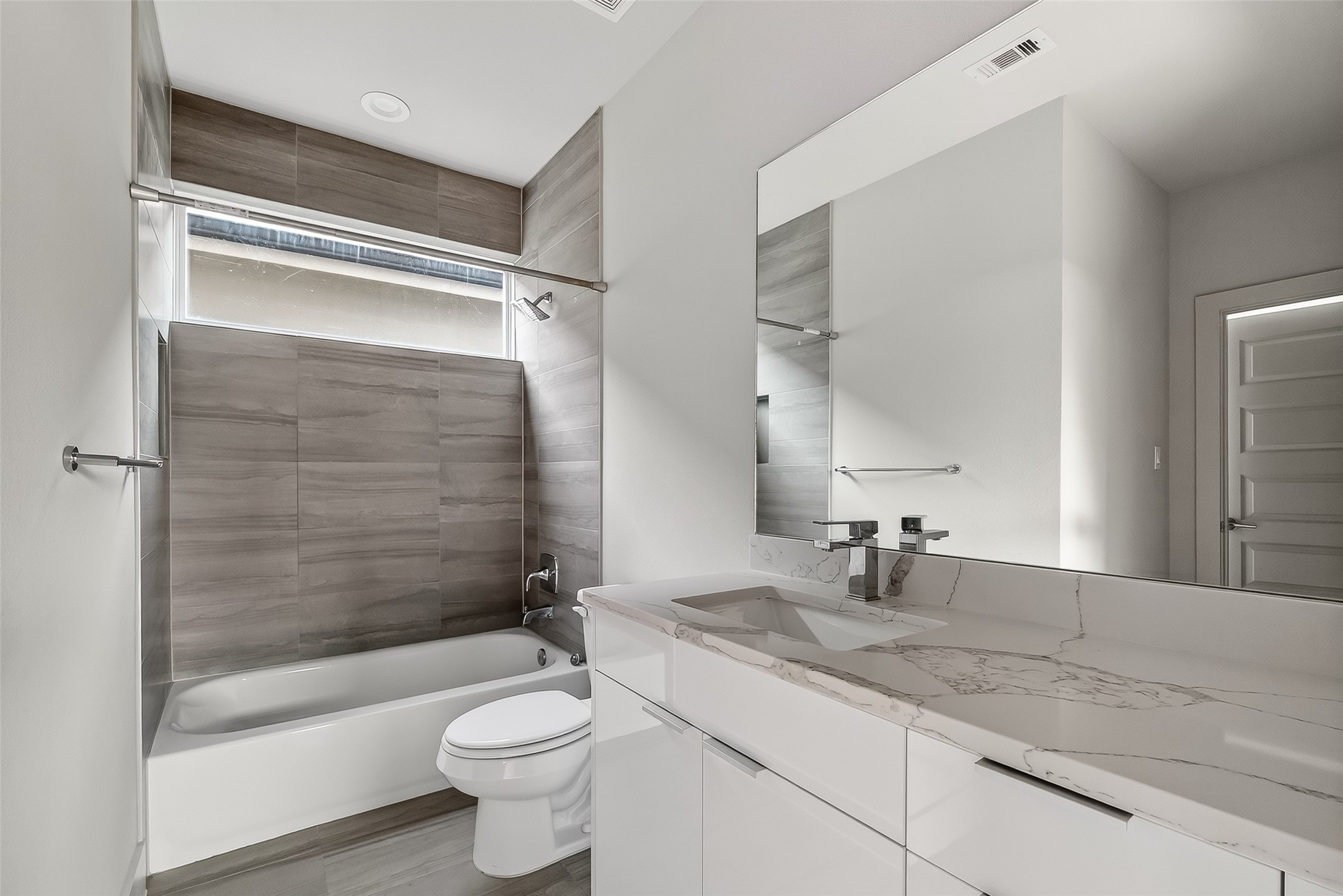 5703 Pampero Lane Houston, TX 77092 - Photo 22 of 41 a bathroom with a granite countertop toilet sink and shower