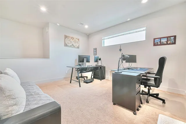 a living room with furniture and a piano