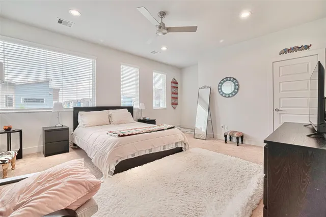 a bedroom with bed and a chandelier