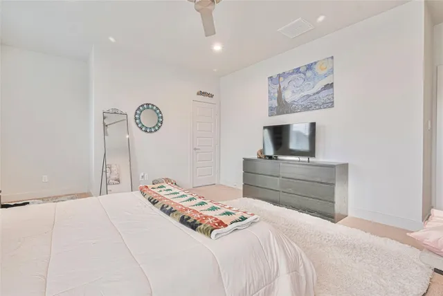 a bedroom with a bed and a television