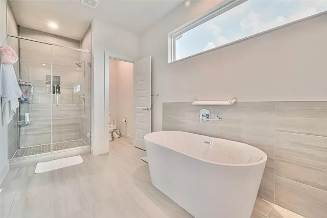a bathroom with a bathtub and shower