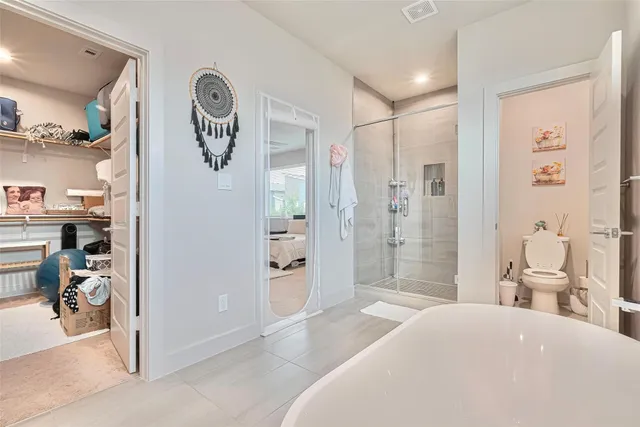 a bedroom with a bed and a view of bathroom