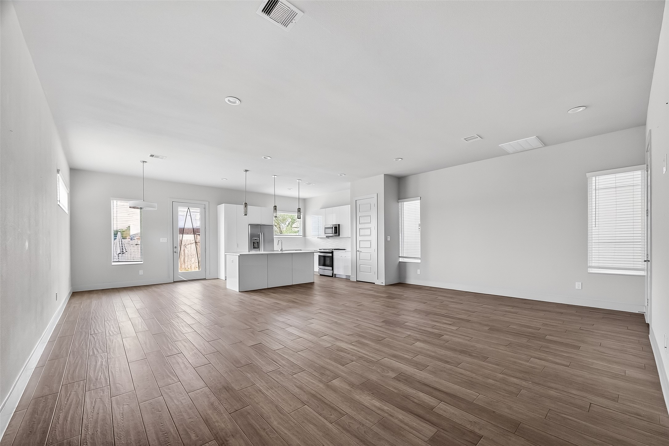 5703 Pampero Lane Houston, TX 77092 - Photo 8 of 41 a view of empty room with wooden floor and window