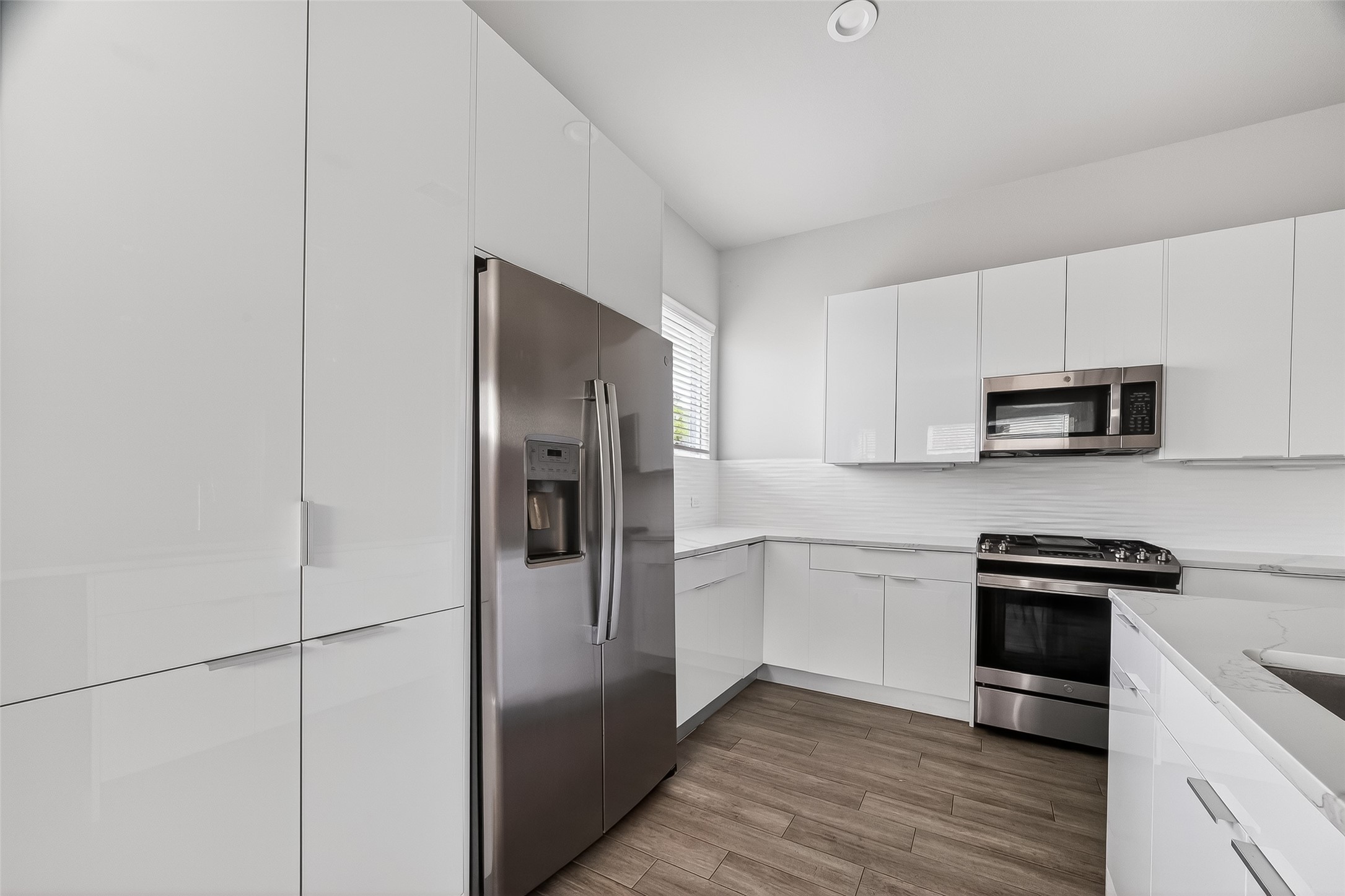 5703 Pampero Lane Houston, TX 77092 - Photo 9 of 41 a kitchen with stainless steel appliances a refrigerator stove and microwave