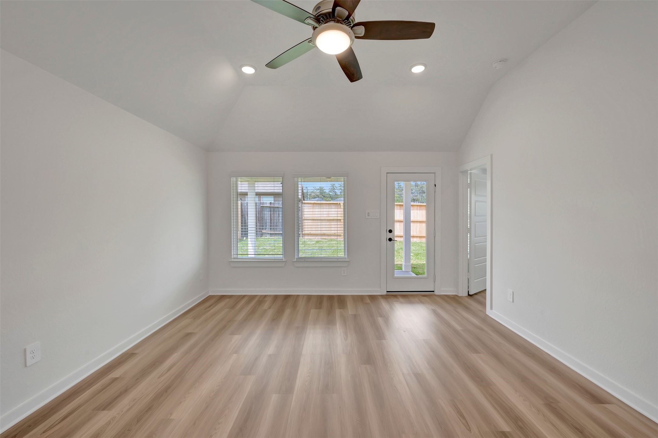 759 Hackberry Branch Magnolia, TX 77354 - Photo 3 of 43 an empty room with wooden floor fan and windows