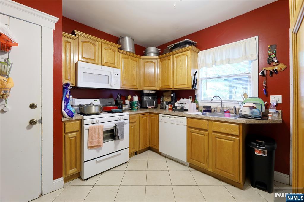 274 Goffle Road Hawthorne, NJ 07506 - Photo 11 of 31 a kitchen with stainless steel appliances granite countertop a sink and cabinets
