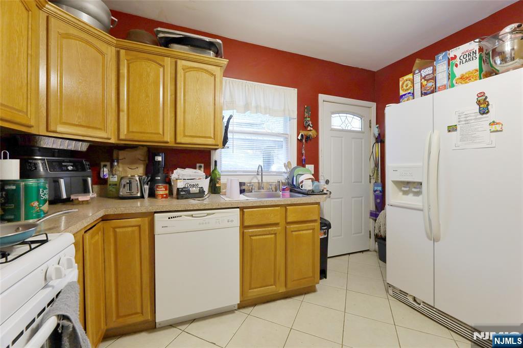 274 Goffle Road Hawthorne, NJ 07506 - Photo 12 of 31 a kitchen with a refrigerator and cabinets