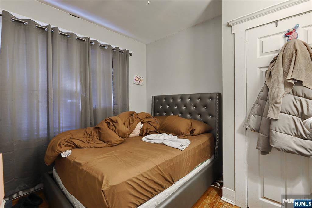 274 Goffle Road Hawthorne, NJ 07506 - Photo 15 of 31 a bedroom with a bed and a walk in closet