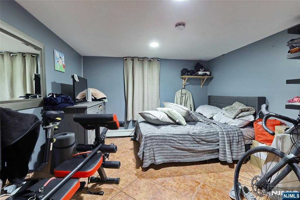 274 Goffle Road Hawthorne, NJ 07506 - Photo 18 of 31 a bedroom with furniture and a gym equipment