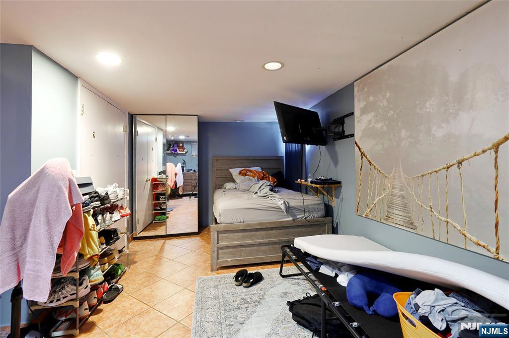 274 Goffle Road Hawthorne, NJ 07506 - Photo 20 of 31 a bedroom with furniture and a gym equipment