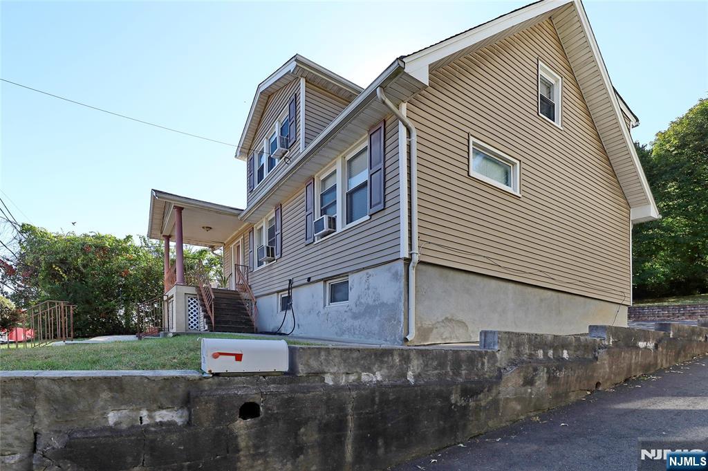 274 Goffle Road Hawthorne, NJ 07506 - Photo 2 of 31 a view of a white building among the street with palm trees
