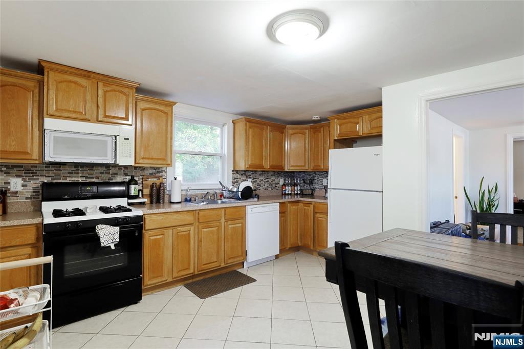274 Goffle Road Hawthorne, NJ 07506 - Photo 21 of 31 a kitchen with granite countertop cabinets a counter space and stainless steel appliances