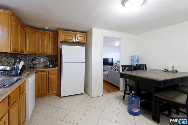 a living room with furniture a flat screen tv and a window