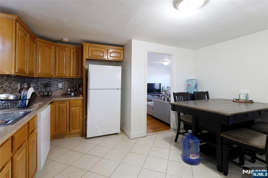 274 Goffle Road Hawthorne, NJ 07506 - Photo 23 of 31 a kitchen with refrigerator and cabinets