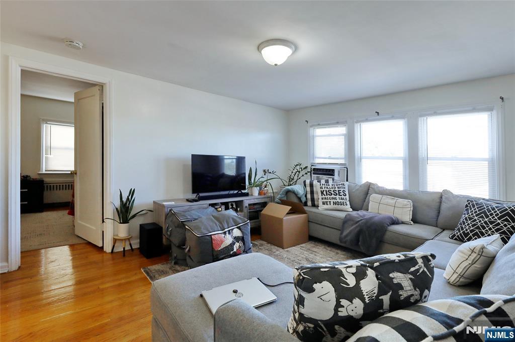 274 Goffle Road Hawthorne, NJ 07506 - Photo 24 of 31 a living room with furniture and a flat screen tv