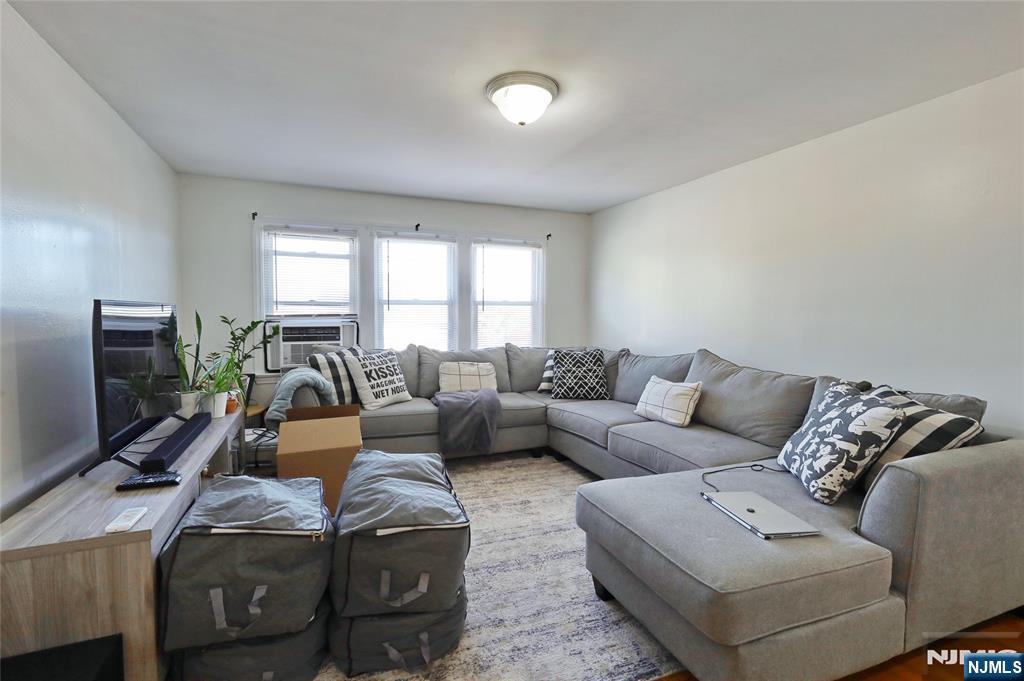 274 Goffle Road Hawthorne, NJ 07506 - Photo 25 of 31 a living room with furniture a flat screen tv and a window