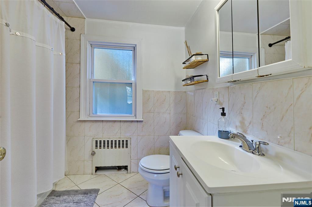 274 Goffle Road Hawthorne, NJ 07506 - Photo 26 of 31 a bathroom with a sink a toilet and shower