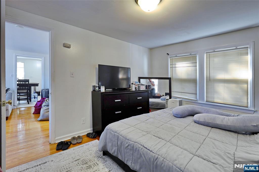 274 Goffle Road Hawthorne, NJ 07506 - Photo 28 of 31 a bedroom with a bed and wooden floor