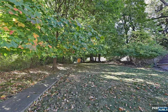 a view of a house with wooden deck and furniture