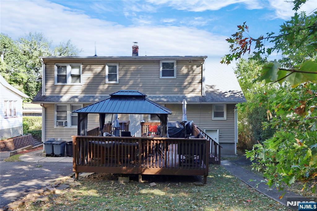 274 Goffle Road Hawthorne, NJ 07506 - Photo 7 of 31 a view of a house with wooden deck and furniture