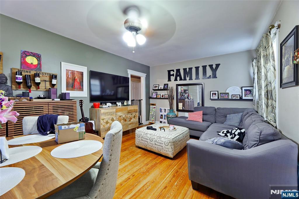 274 Goffle Road Hawthorne, NJ 07506 - Photo 10 of 31 a living room with furniture kitchen view and a flat screen tv