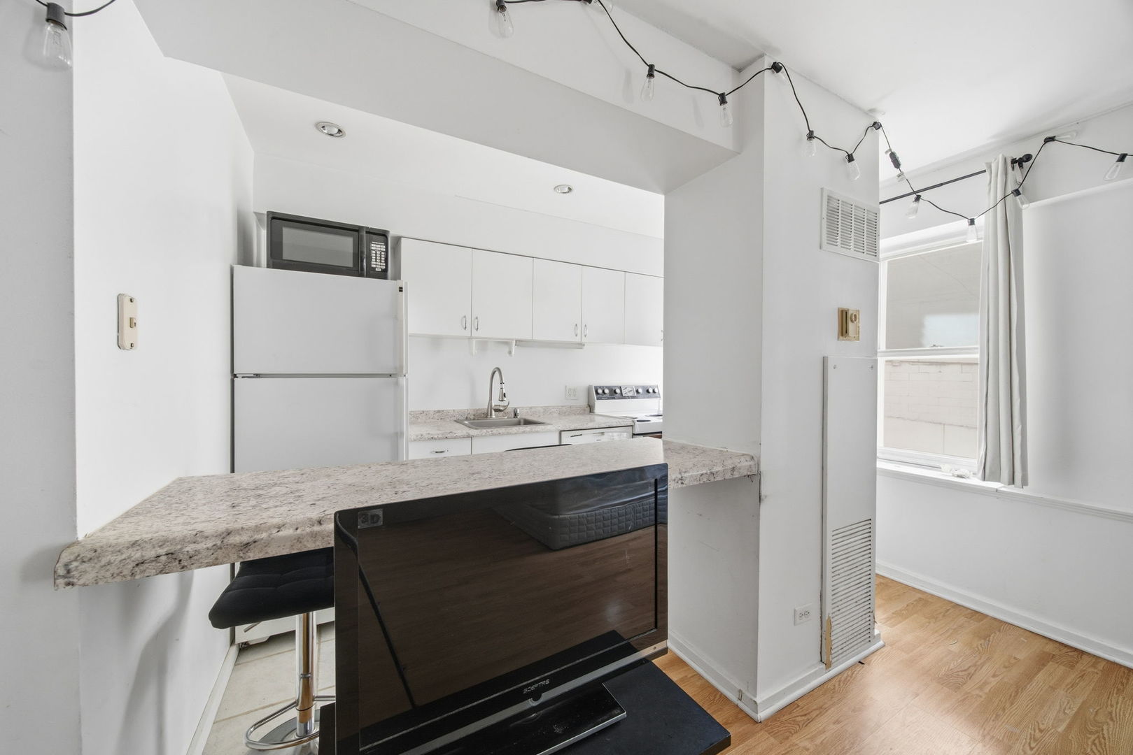 40 East 9th Street, Unit 712 Chicago, IL 60605 - Photo 7 of 26 a kitchen with a sink appliances and cabinets