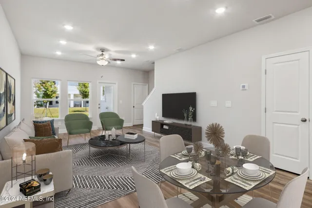 a kitchen with granite countertop white cabinets and refrigerator