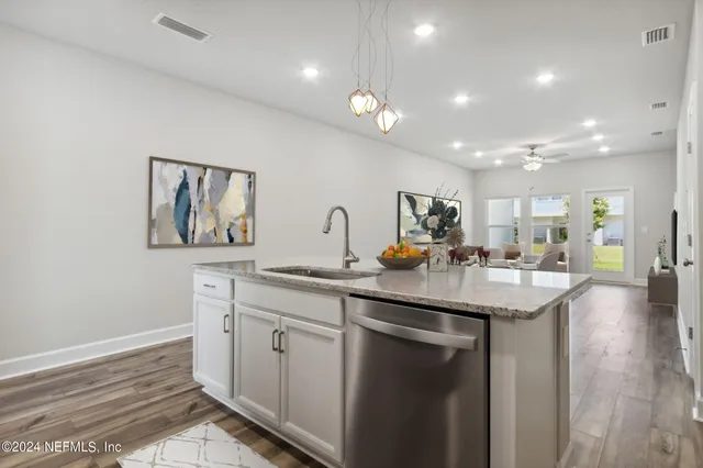 a view of a kitchen with a sink and a stove top oven