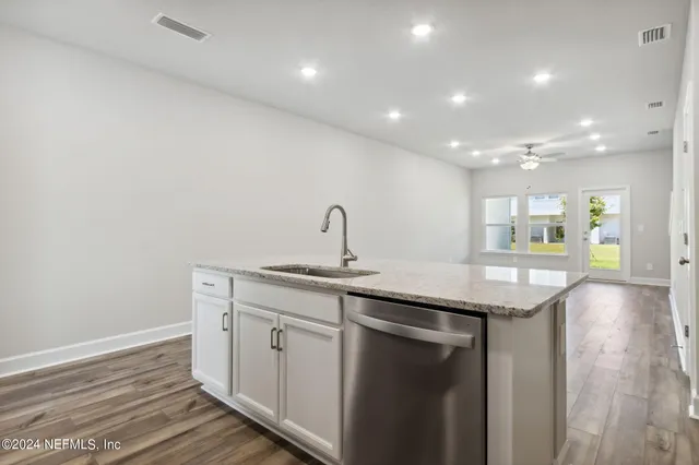 a bathroom with a sink mirror and toilet