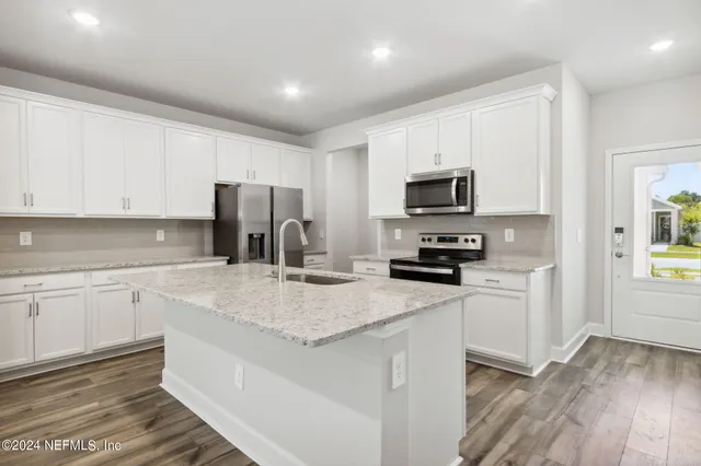 a bedroom with a large bed and a large window