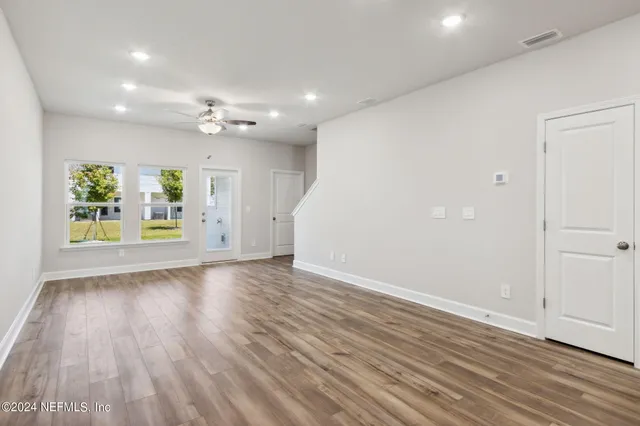 a bedroom with a bed and a potted plant