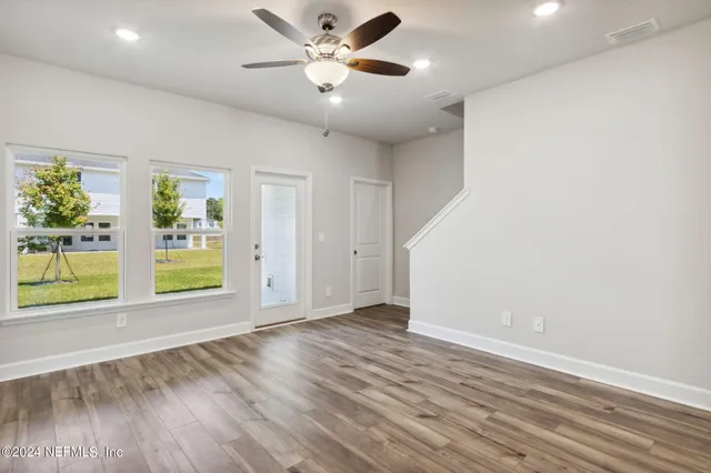 a view of empty room with ceiling fan