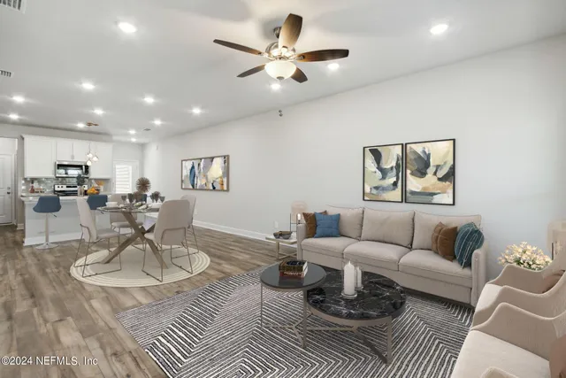 a front view of house with yard and trees in the background