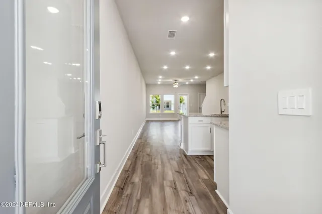 a living room with furniture a flat screen tv and a large window