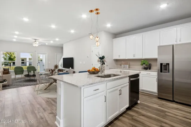 a living room with furniture and kitchen view