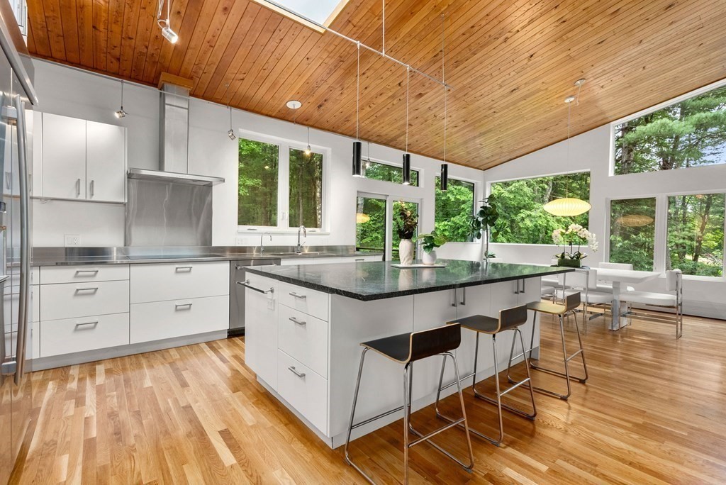 7 Spruce Hill Road Weston, MA 02493 - Photo 11 of 40 a kitchen with stainless steel appliances granite countertop a stove a sink and white cabinets with wooden floor