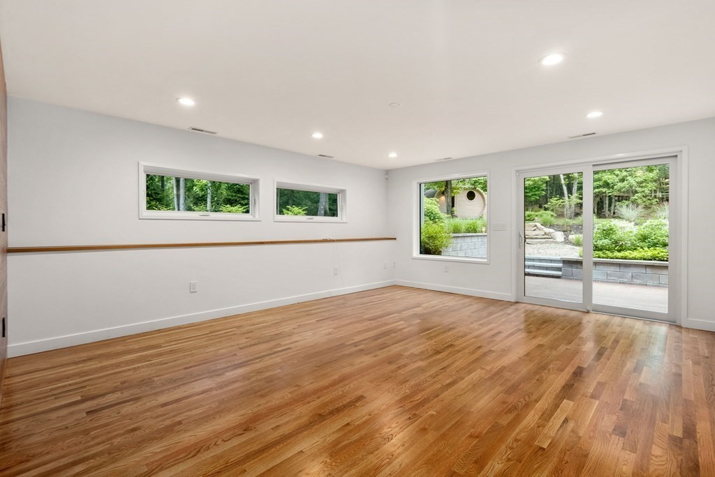 7 Spruce Hill Road Weston, MA 02493 - Photo 18 of 40 a view of an empty room with wooden floor and a window