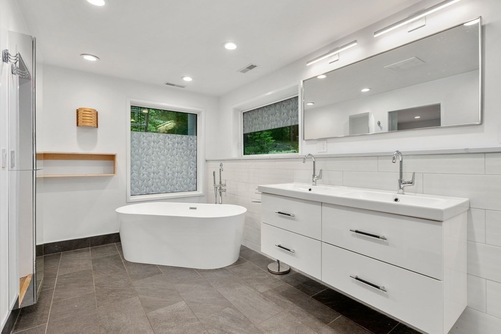 7 Spruce Hill Road Weston, MA 02493 - Photo 19 of 40 a bathroom with a double vanity sink mirror and bathtub