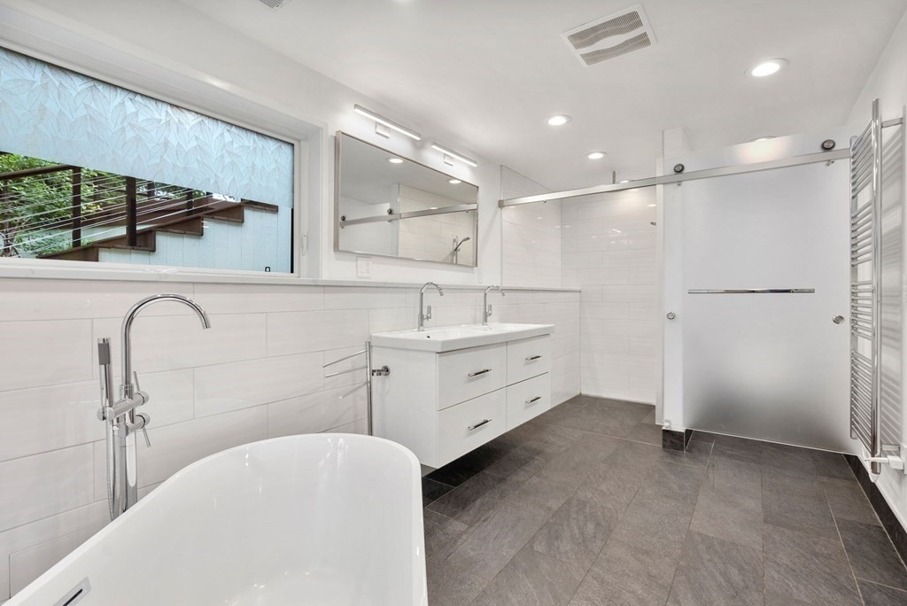 7 Spruce Hill Road Weston, MA 02493 - Photo 20 of 40 a bathroom with a double vanity sink a mirror and a shower