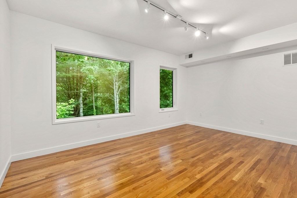 7 Spruce Hill Road Weston, MA 02493 - Photo 24 of 40 an empty room with wooden floor and windows