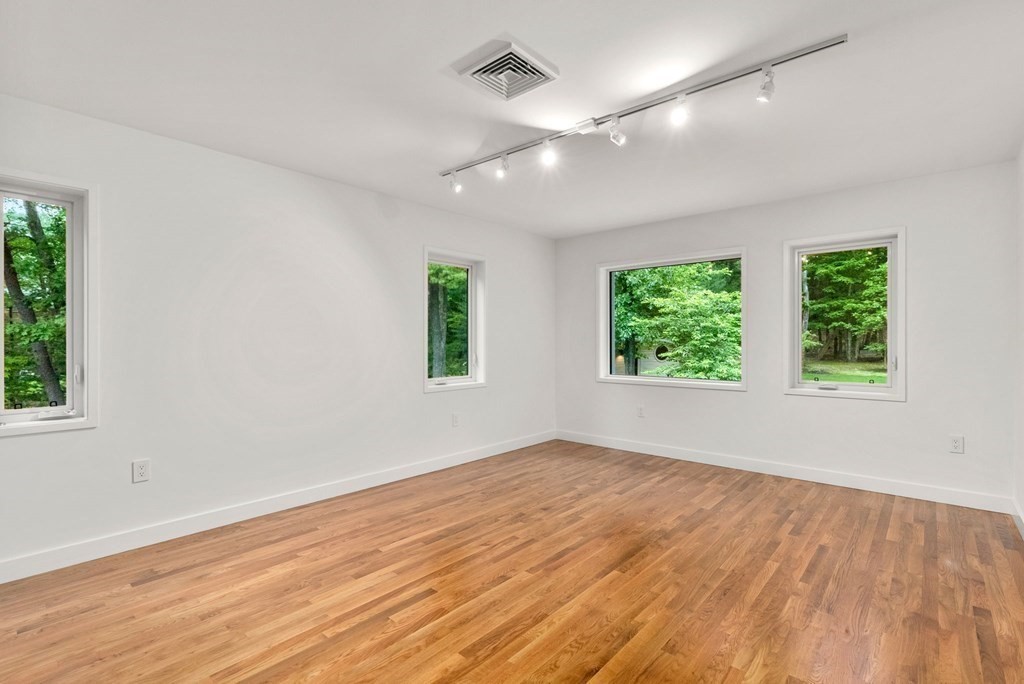 7 Spruce Hill Road Weston, MA 02493 - Photo 25 of 40 an empty room with wooden floor and windows