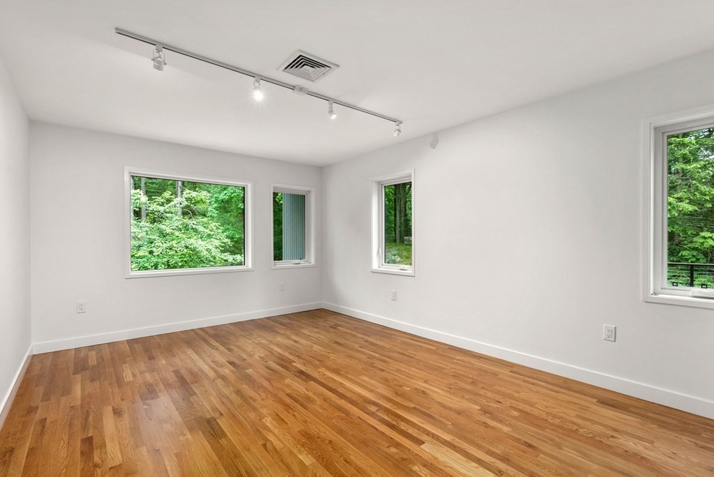 7 Spruce Hill Road Weston, MA 02493 - Photo 26 of 40 a view of an empty room with wooden floor and a window