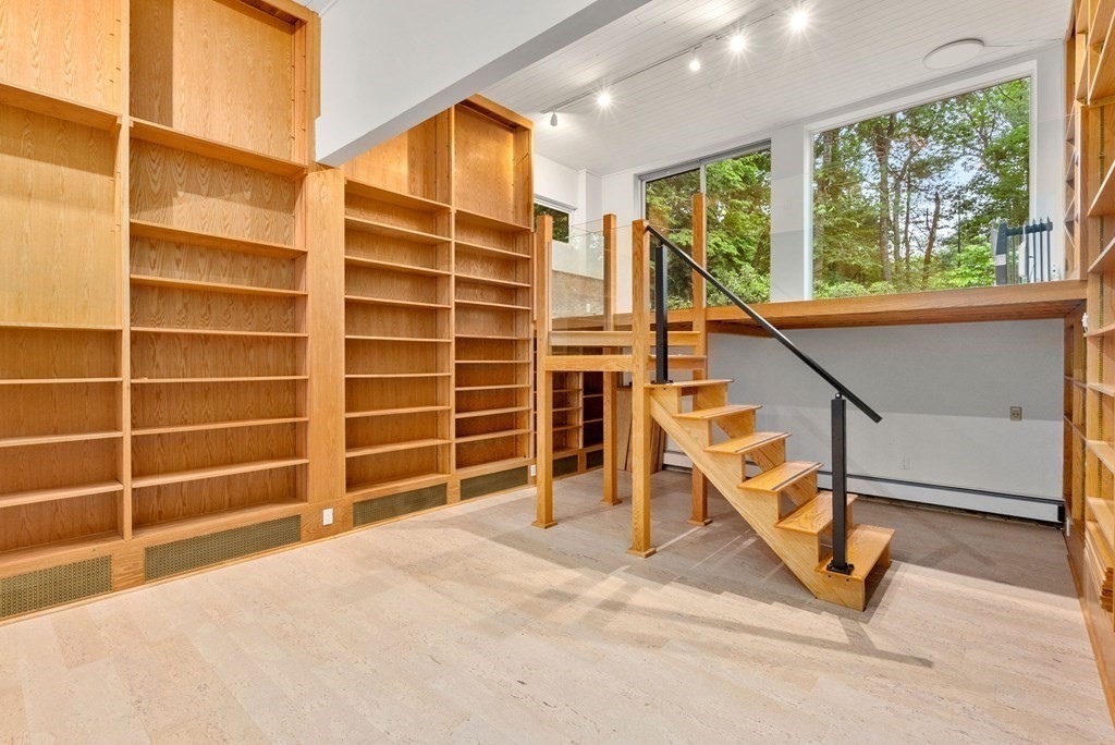 7 Spruce Hill Road Weston, MA 02493 - Photo 28 of 40 a view of an empty room with wooden floor and a window