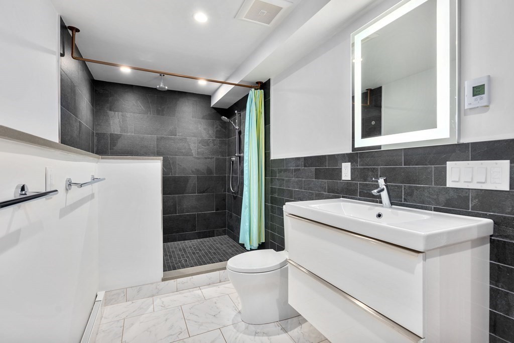7 Spruce Hill Road Weston, MA 02493 - Photo 32 of 40 a bathroom with a sink toilet and shower
