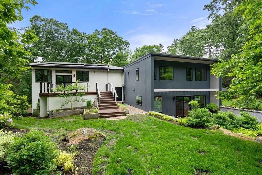 7 Spruce Hill Road Weston, MA 02493 - Photo 34 of 40 a front view of house with a garden and plants