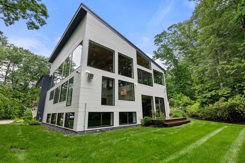 7 Spruce Hill Road Weston, MA 02493 - Photo 36 of 40 a front view of a house with a yard